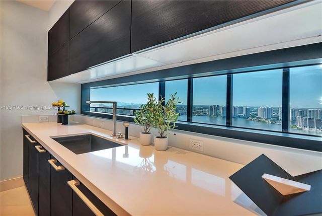 a kitchen with a sink and large window