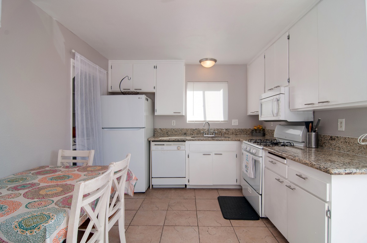 442 Felicita Avenue Spring Valley, CA 91977 - Photo 5 of 12 Gas range and full size laundry in kitchen