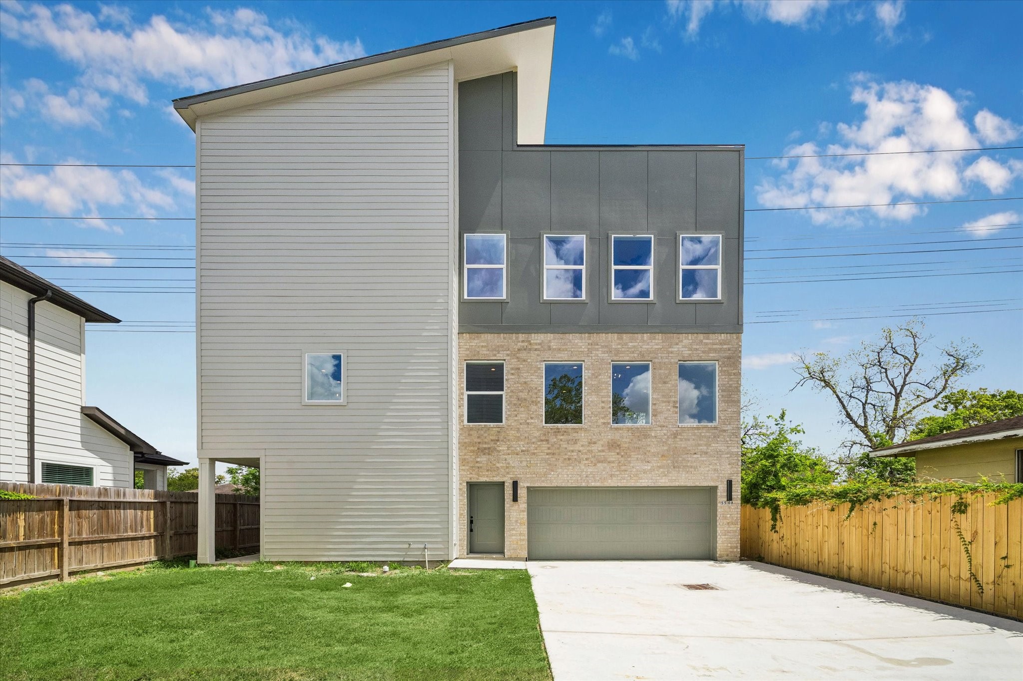 a front view of a house with a yard and a garage
