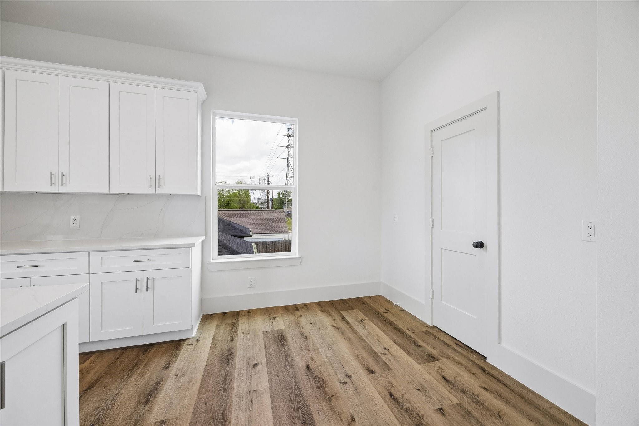 5508 Hardy Street Houston, TX 77009 - Photo 12 of 31 a view of empty room with wooden floor and cabinet
