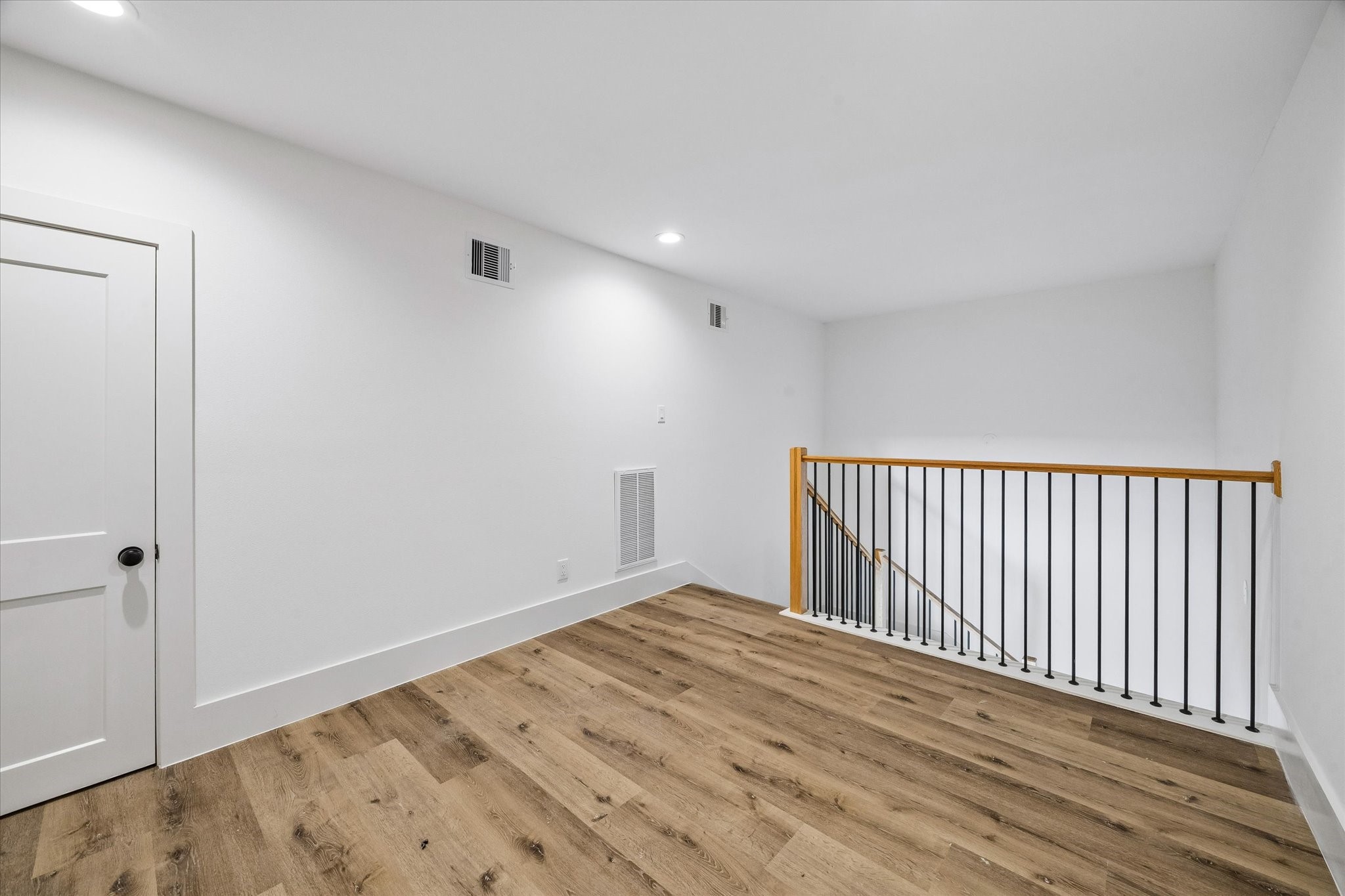 5508 Hardy Street Houston, TX 77009 - Photo 19 of 31 wooden floor in a hall with a window