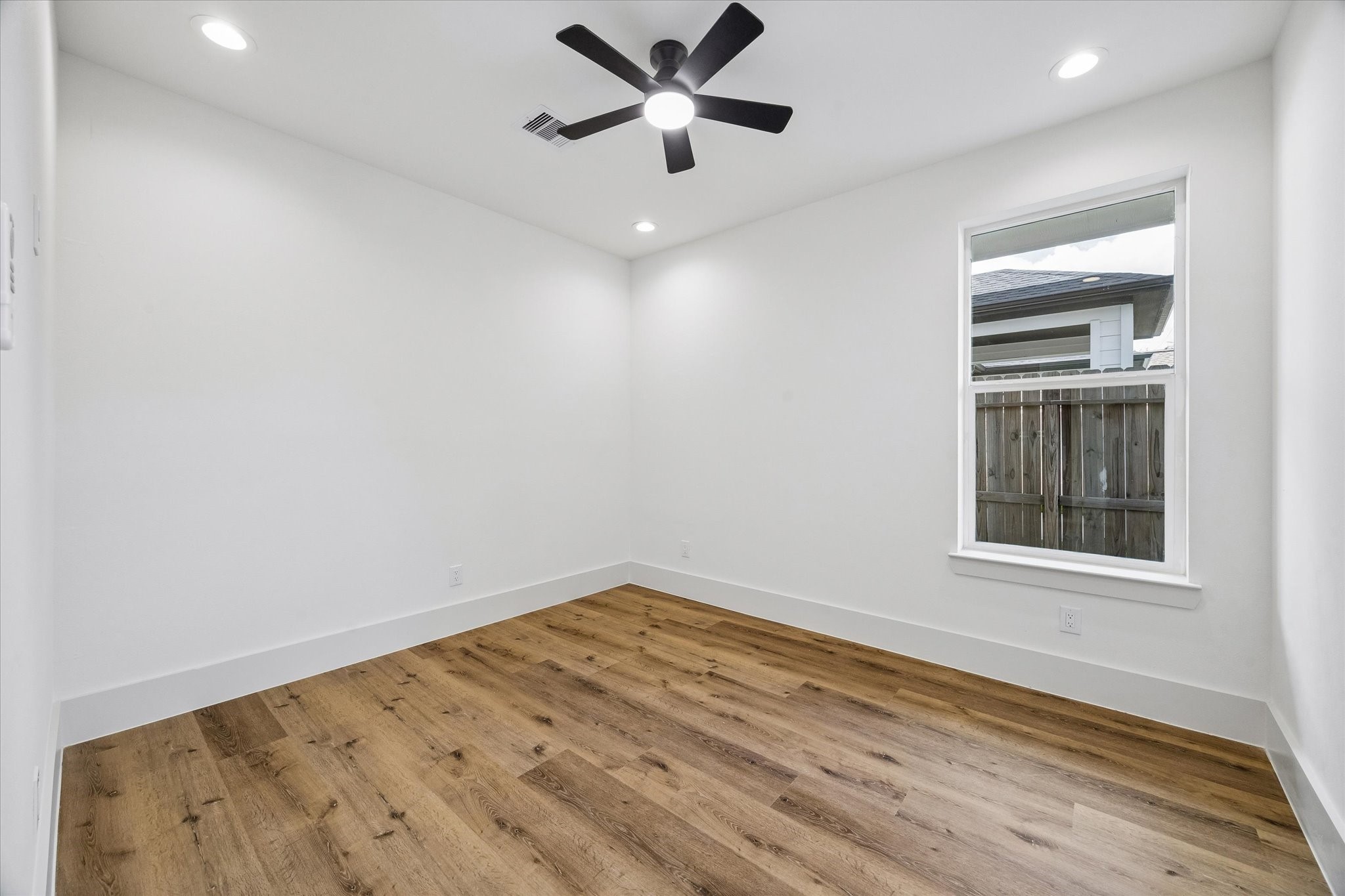 5508 Hardy Street Houston, TX 77009 - Photo 22 of 31 wooden floor in an empty room with a window