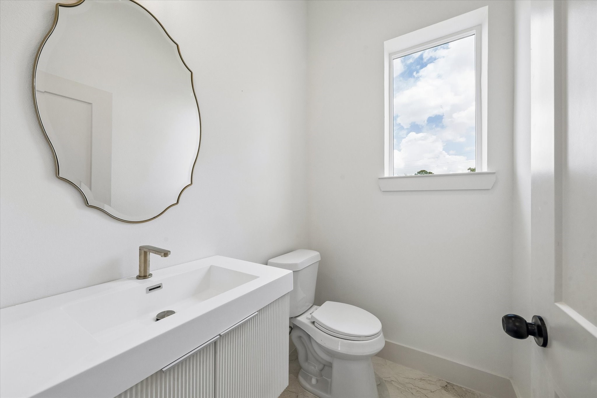 5508 Hardy Street Houston, TX 77009 - Photo 24 of 31 a bathroom with a sink mirror and toilet