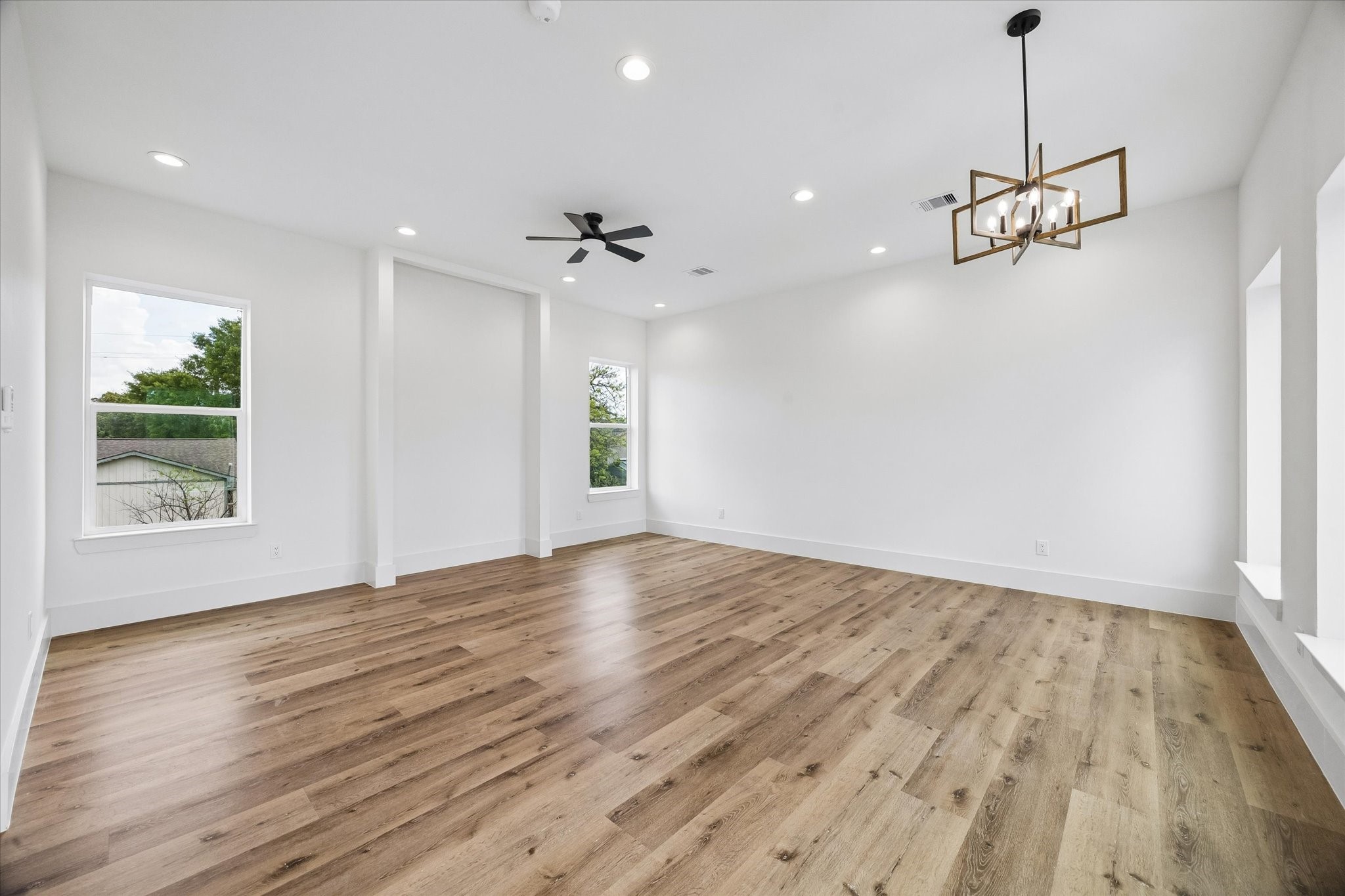 5508 Hardy Street Houston, TX 77009 - Photo 7 of 31 a view of an empty room with wooden floor and a window
