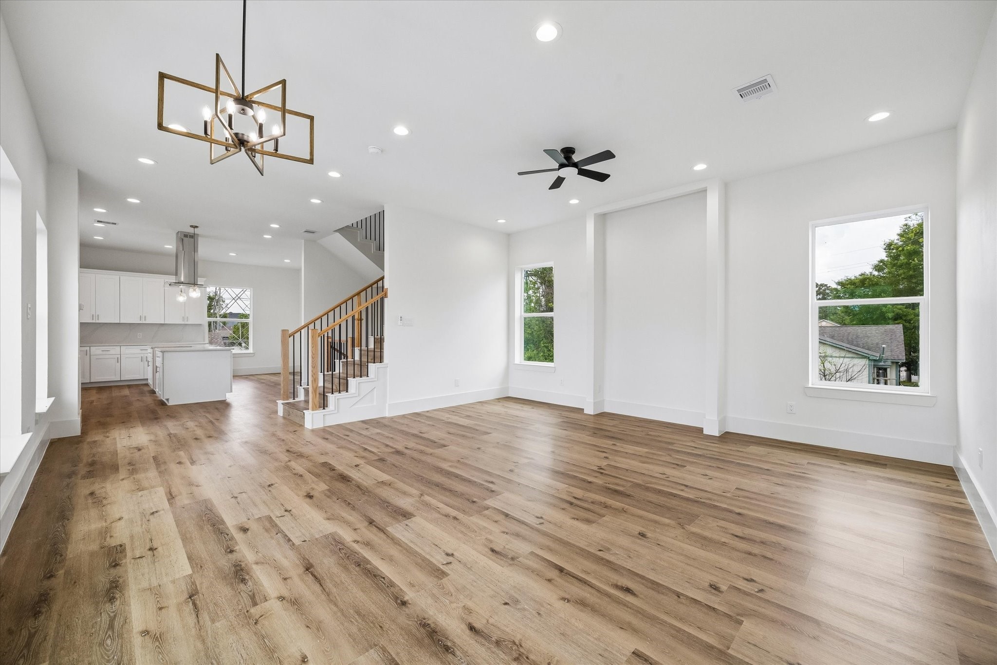 5508 Hardy Street Houston, TX 77009 - Photo 8 of 31 a view of an empty room and kitchen view with wooden floor