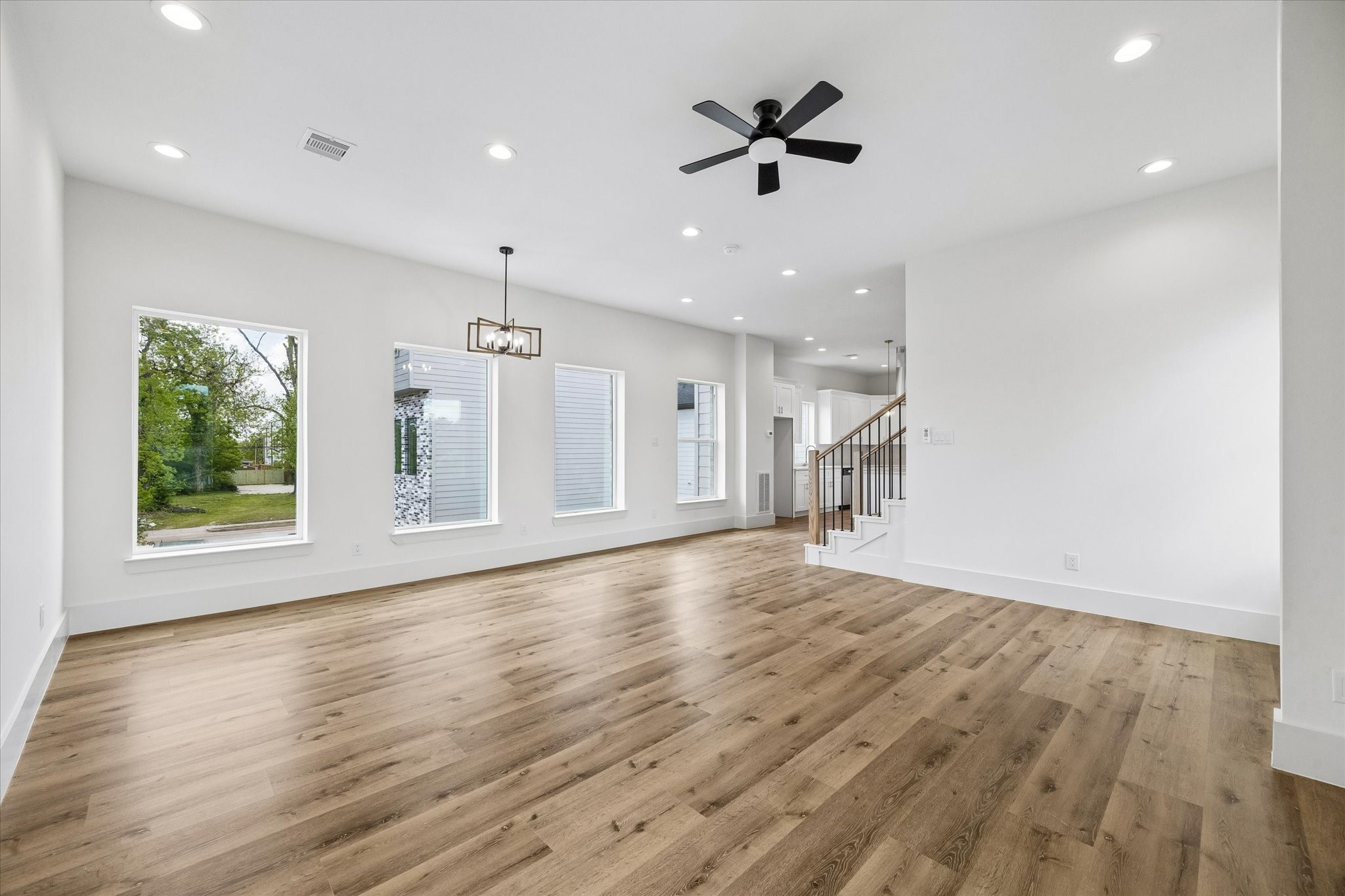 5508 Hardy Street Houston, TX 77009 - Photo 9 of 31 a view of an empty room with a window and wooden floor