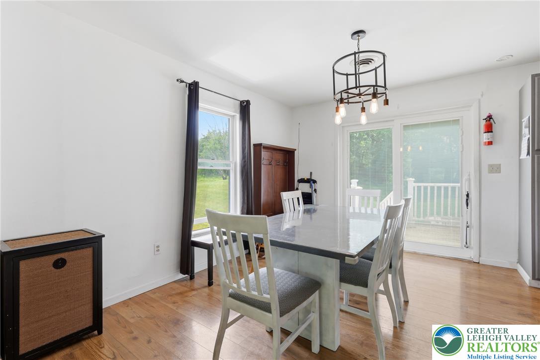 732 Bushkill Center Road Nazareth, PA 18064 - Photo 9 of 43 Hardwood floors and a modern light fixture enhance this well-appointed dining space.