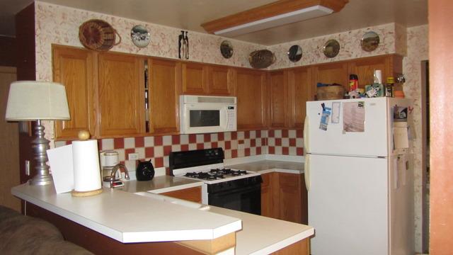 485 Rebecca Lane Bolingbrook, IL 60440 - Photo 7 of 16 a kitchen with stainless steel appliances granite countertop a sink stove and refrigerator