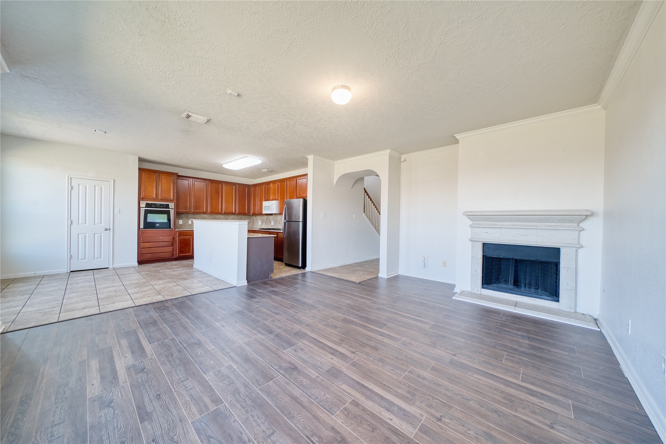 6610 Autumn Sunset Lane Spring, TX 77379 - Photo 16 of 45 a view of a electric appliances in kitchen and empty room with wooden floor