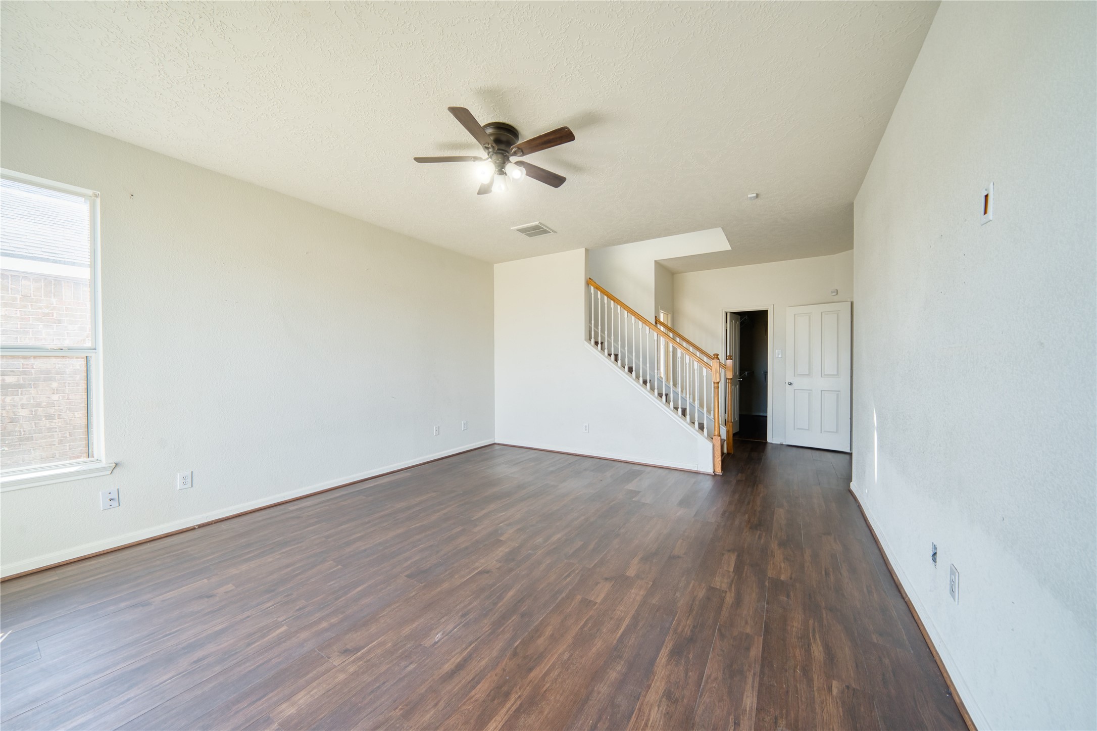 6610 Autumn Sunset Lane Spring, TX 77379 - Photo 23 of 45 a view of an empty room with wooden floor and a window