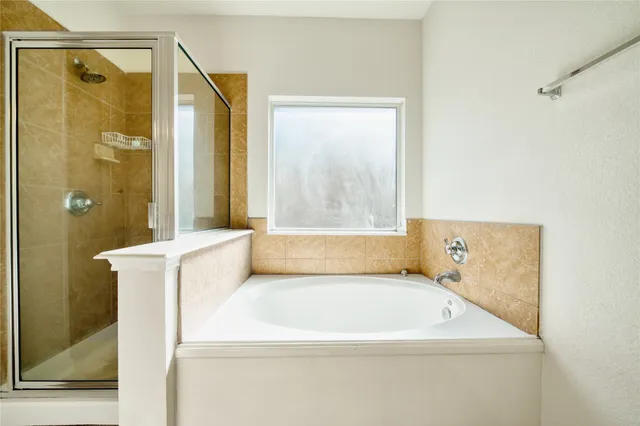 a bathroom with a bathtub and shower