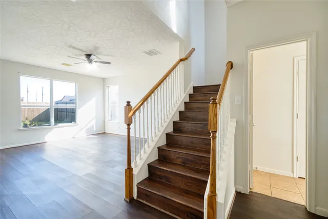 a view of staircase with wooden floor and front door