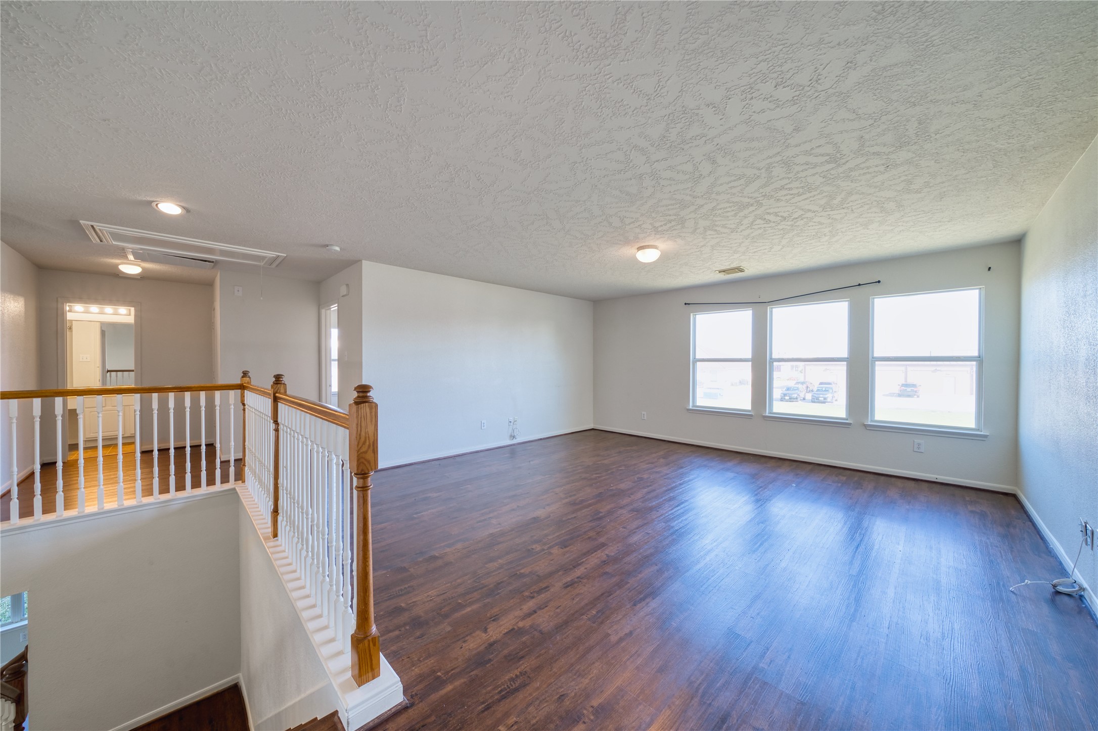 6610 Autumn Sunset Lane Spring, TX 77379 - Photo 36 of 45 a view of an empty room with wooden floor and a window