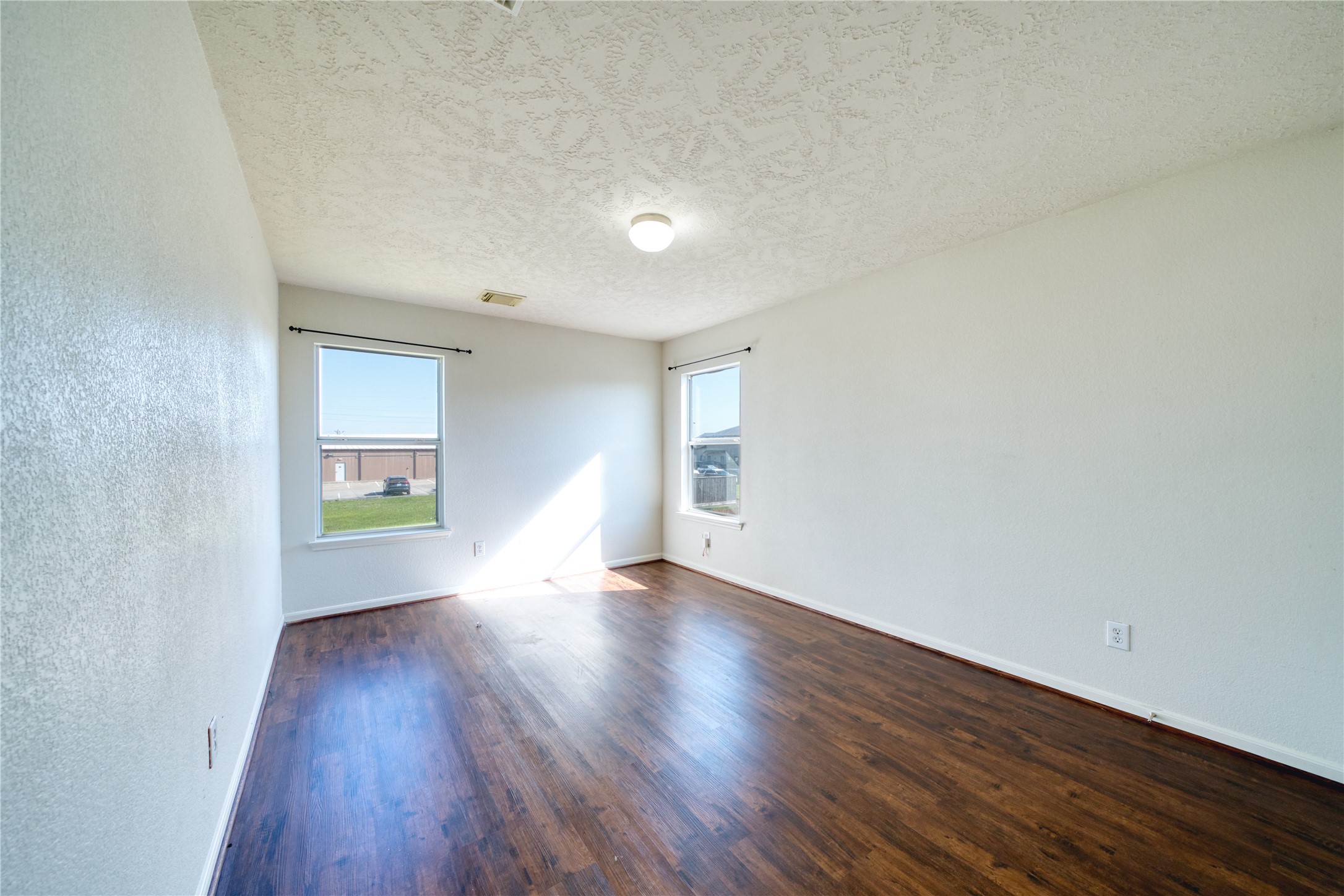 6610 Autumn Sunset Lane Spring, TX 77379 - Photo 41 of 45 a view of an empty room with wooden floor and a window