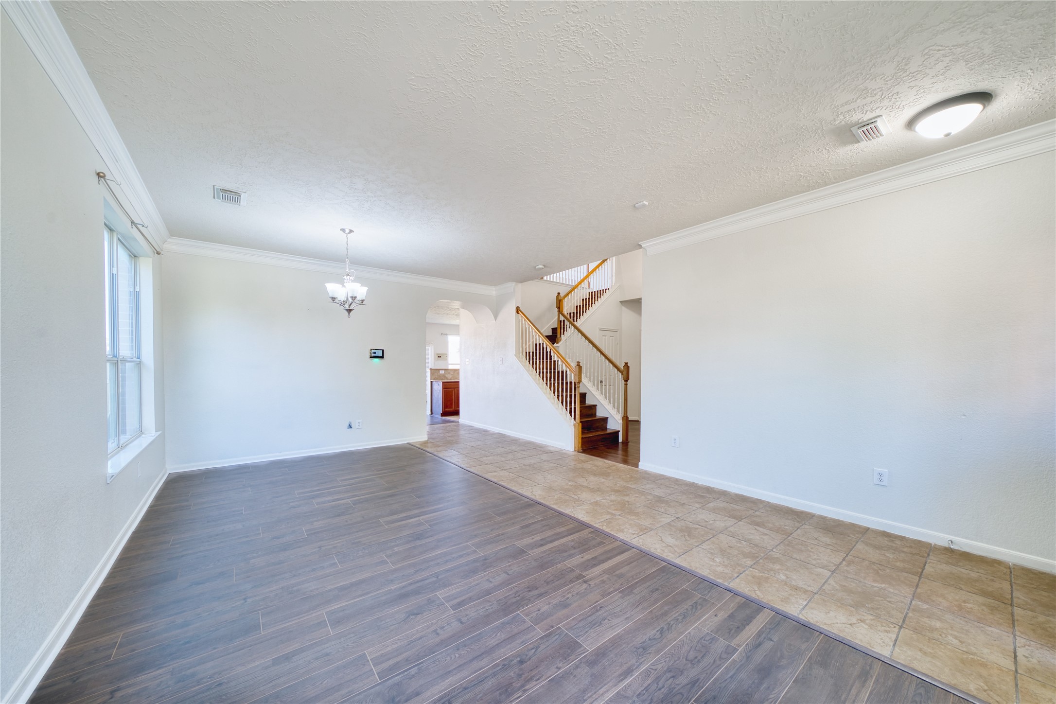 6610 Autumn Sunset Lane Spring, TX 77379 - Photo 8 of 45 a view of an empty room with wooden floor and stairs