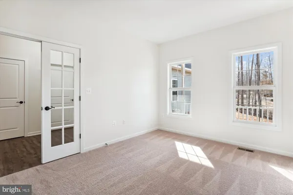 a view of an empty room with windows
