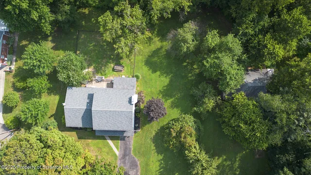 an aerial view of a house with a garden