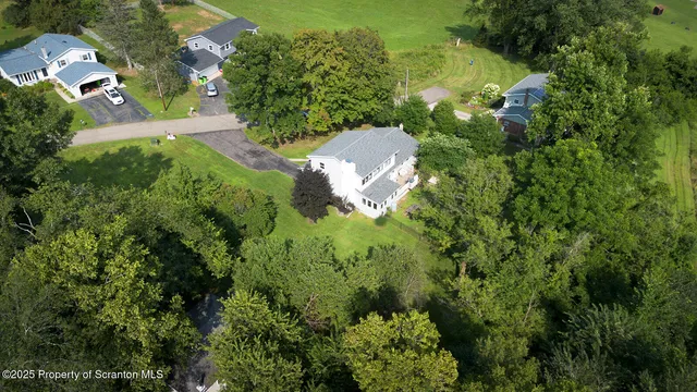 a house view with swimming pool in front of it