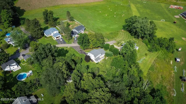 a view of a white house with a flower garden