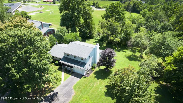 a kitchen that has a lot of cabinets and wooden floor