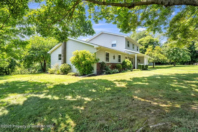 a kitchen with stainless steel appliances granite countertop a sink refrigerator and microwave