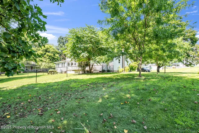 a view of a dining room with furniture wooden floor and chandelier