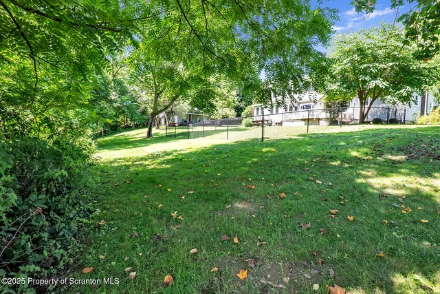 a living room with furniture and floor to ceiling windows