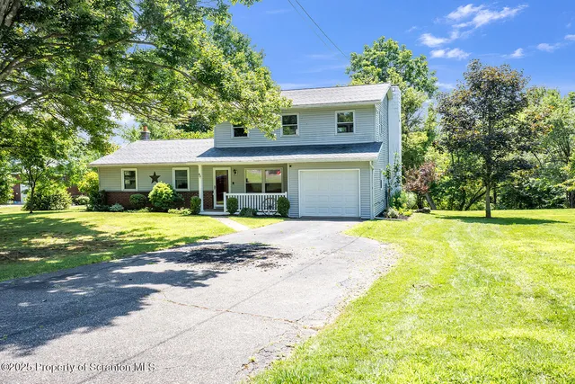 a front view of a house with a yard patio and fire pit