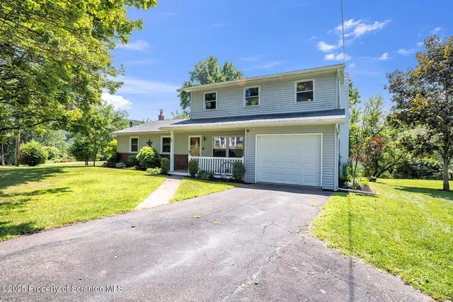an aerial view of a house with garden space and sitting area