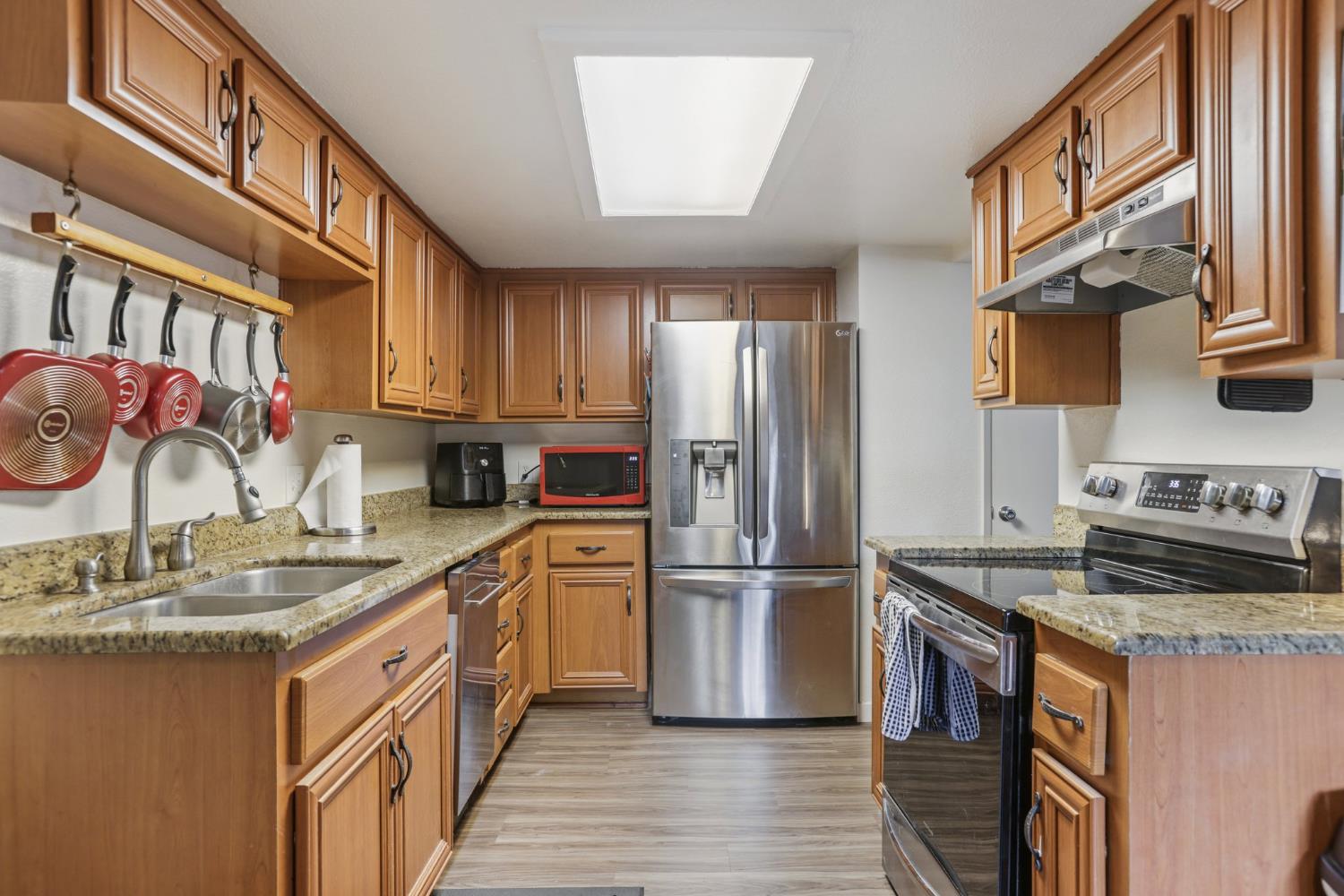 3700 Tully Road, Unit 57 Modesto, CA 95356 - Photo 14 of 34 a kitchen with stainless steel appliances granite countertop a refrigerator a stove a sink and a microwave