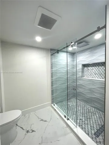 a bathroom with a shower and a toilet