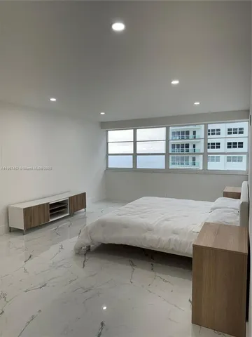 a bedroom with a bed and a dresser in it