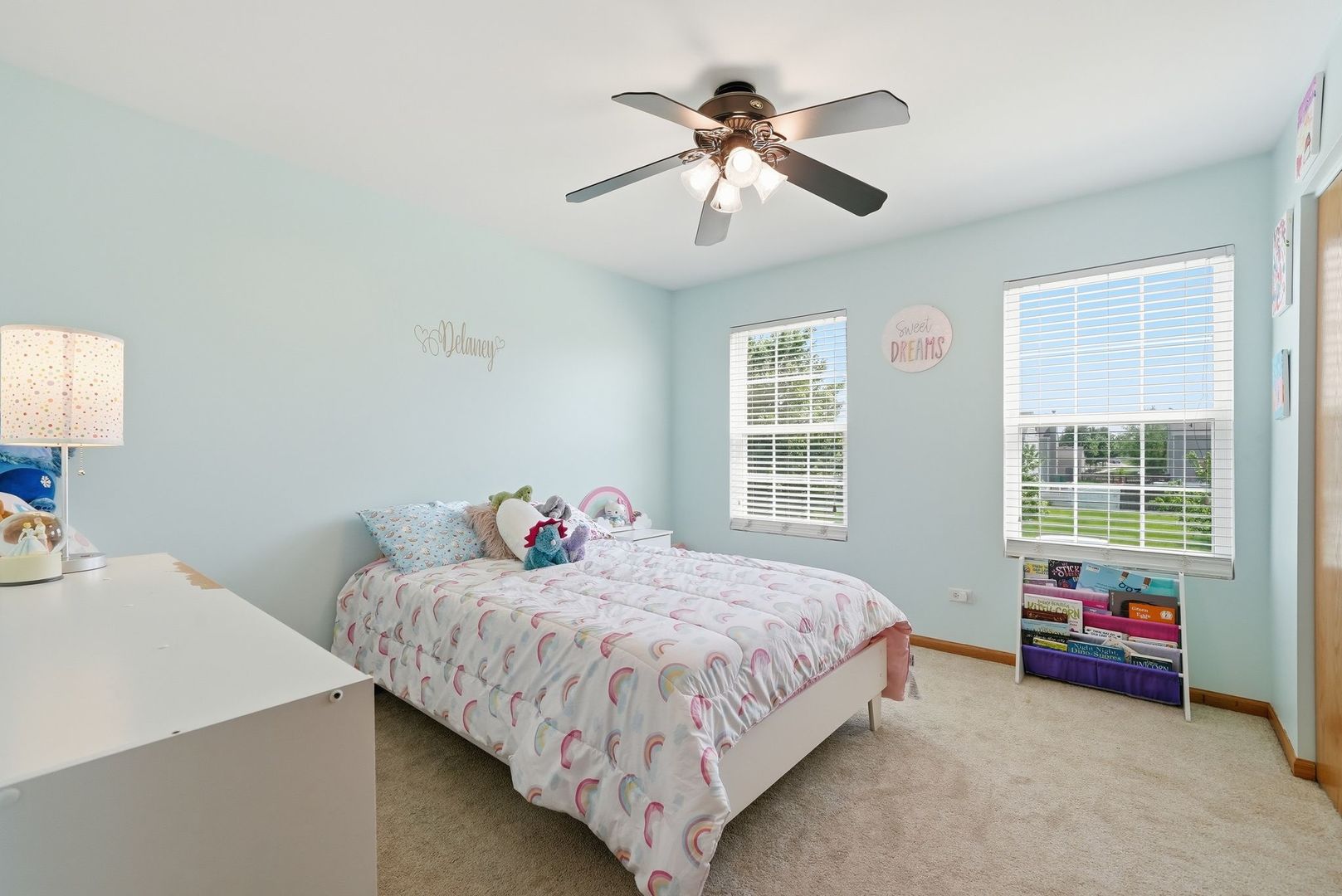 25216 Spring Street Manhattan, IL 60442 - Photo 15 of 28 a bedroom with a bed and a chandelier