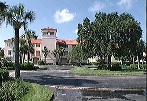 a sign board with a yard and palm trees
