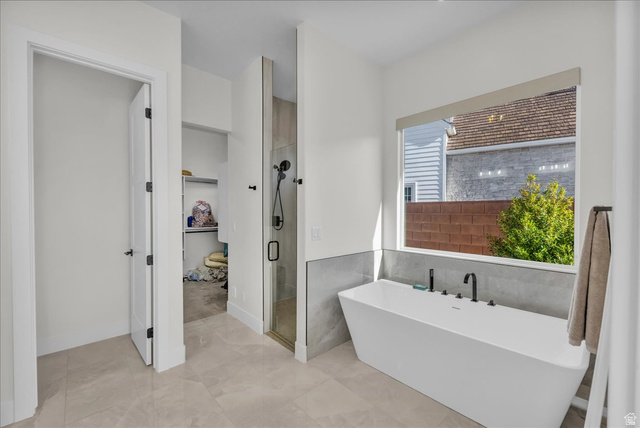 404 North Marsala Way St. George, UT 84770 - Photo 14 of 26 Bathroom featuring a shower stall, a freestanding tub, and tile walls