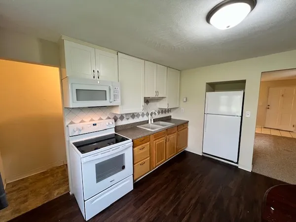 a kitchen with a stove a sink and a refrigerator
