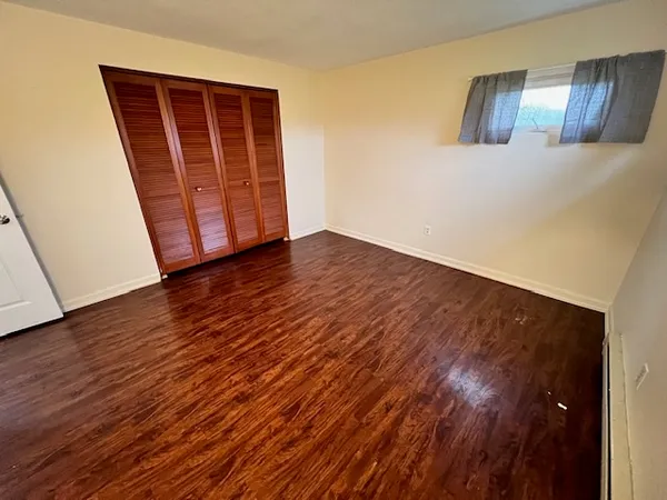 an empty room with wooden floor