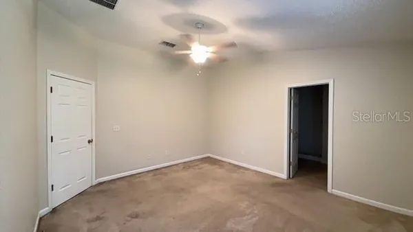 a view of an empty room with a fan