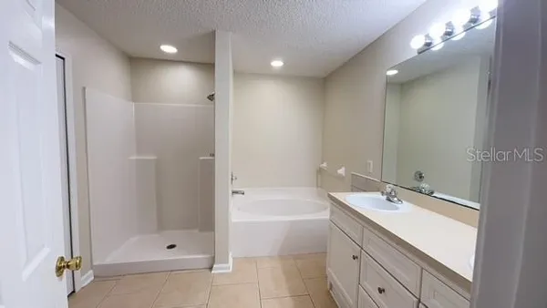 a bathroom with a shower a sink and a mirror