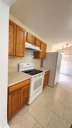 a kitchen with stainless steel appliances granite countertop a sink and a stove