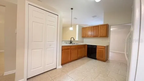 a spacious bathroom with a granite countertop sink a mirror and a bathtub