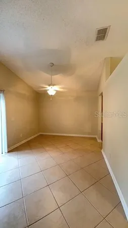 a view of a room with an empty space and a window