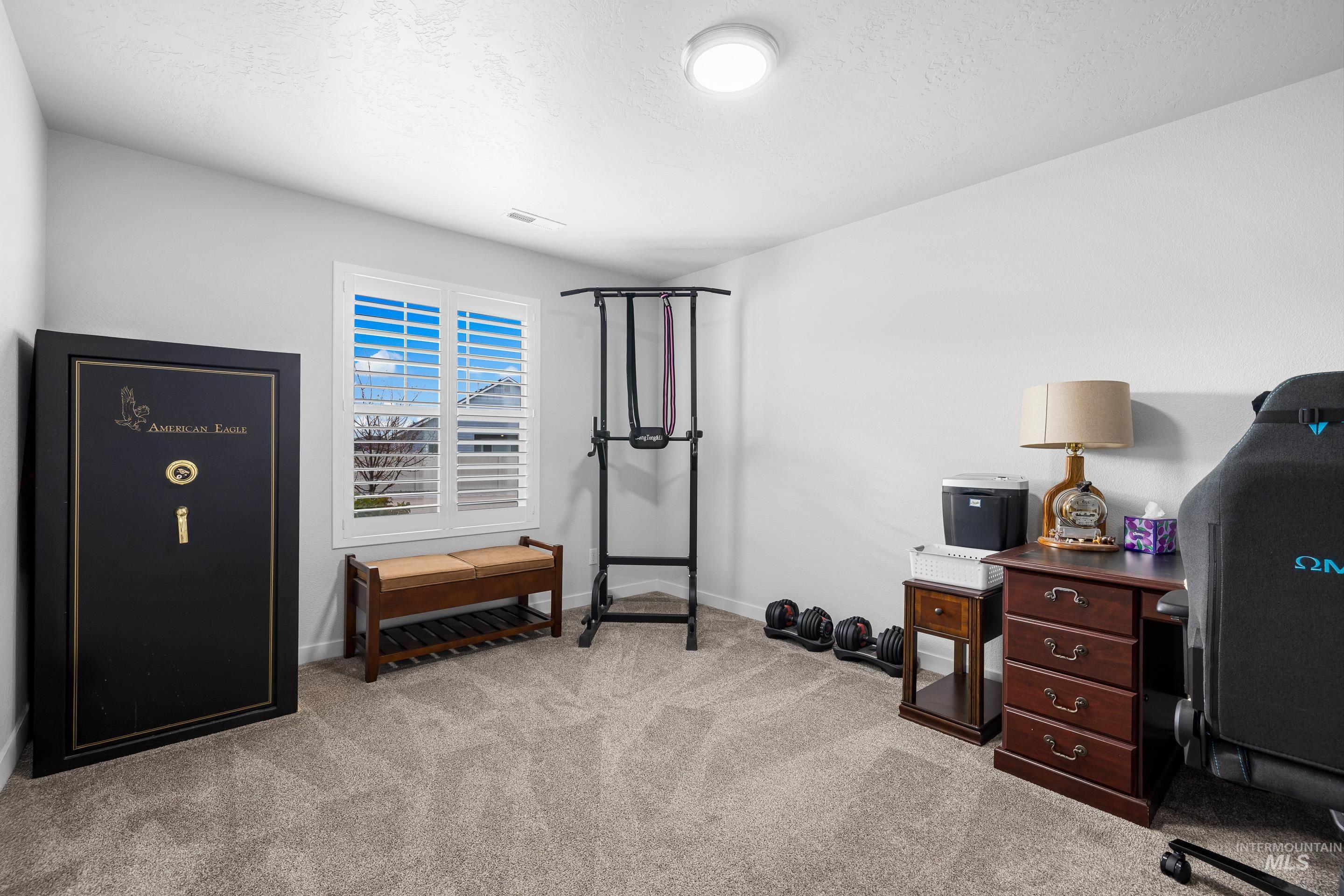 3308 West Zarea Drive Meridian, ID 83642 - Photo 8 of 47 Workout area featuring light colored carpet and a textured ceiling