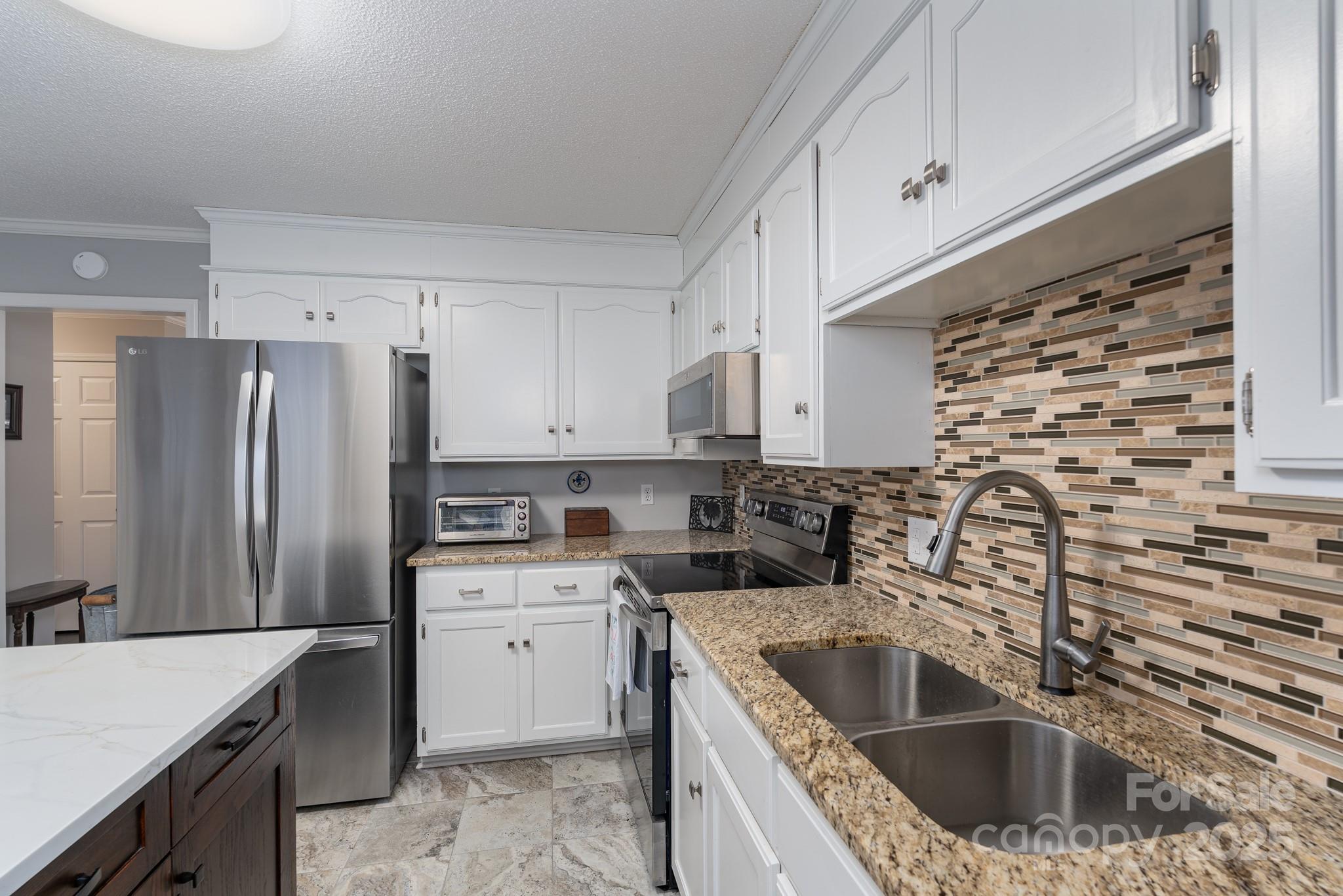 201 Pointe Circle Rock Hill, SC 29732 - Photo 12 of 32 a kitchen with stainless steel appliances granite countertop a sink stove and refrigerator