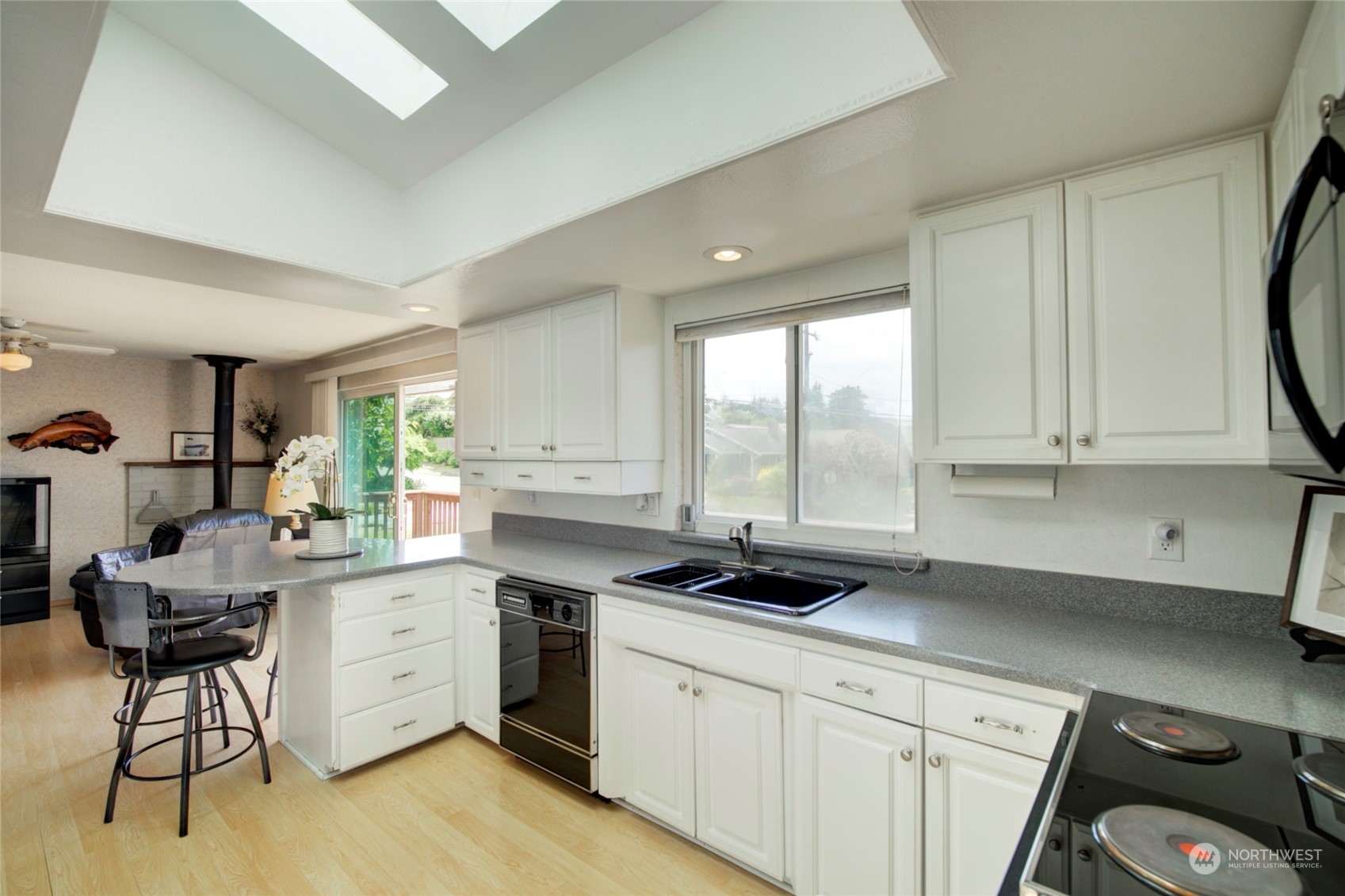 432 Olympic Avenue Edmonds, WA 98020 - Photo 7 of 34 a kitchen with a sink appliances cabinets and furniture