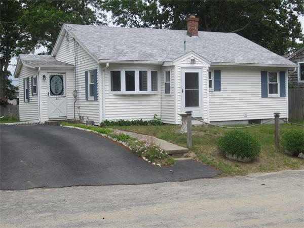 22 Agawam Beach Road Wareham, MA 02571 - Photo 1 of 16 a front view of a house with a yard and garage