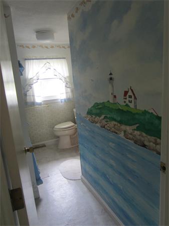 22 Agawam Beach Road Wareham, MA 02571 - Photo 11 of 16 a bathroom with a toilet and a vanity