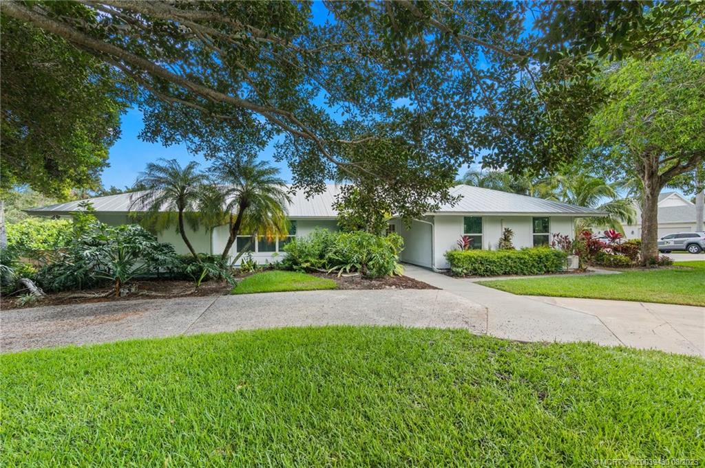 a front view of a house with a yard and a garage