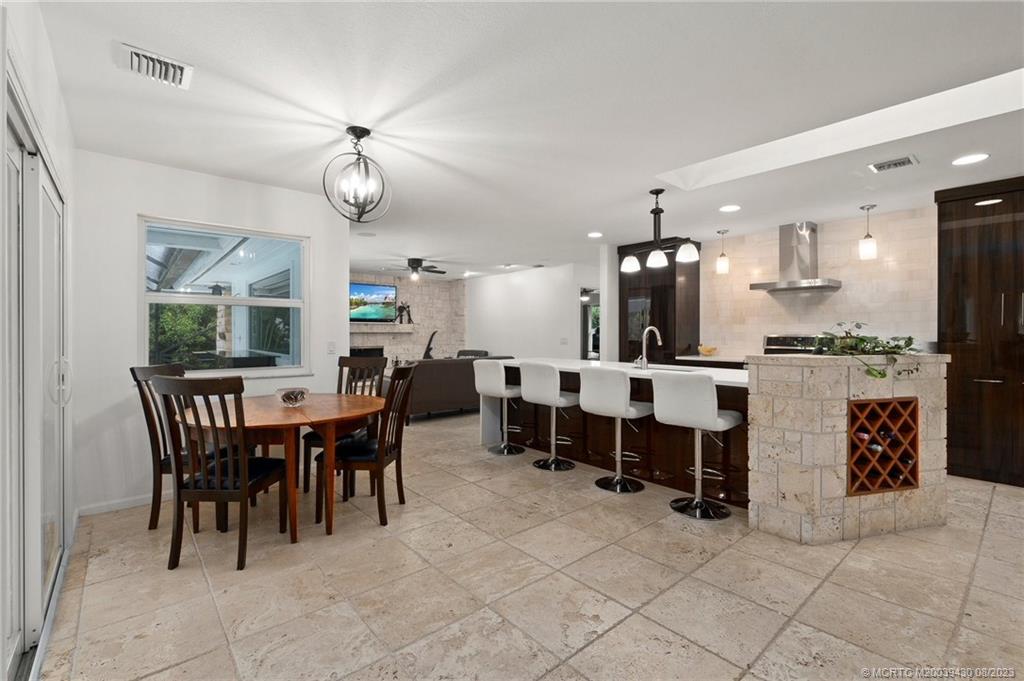 40 North River Road Stuart, FL 34996 - Photo 11 of 51 a large kitchen with a dining table and chairs