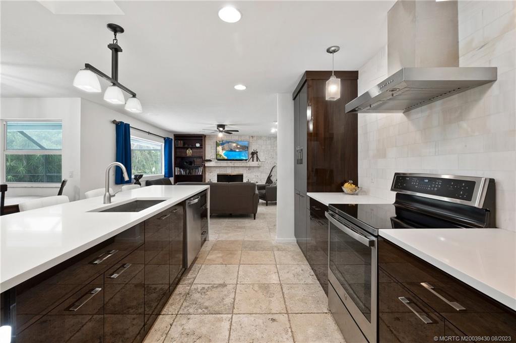 40 North River Road Stuart, FL 34996 - Photo 14 of 51 a large kitchen with stainless steel appliances a sink dishwasher a stove and a refrigerator